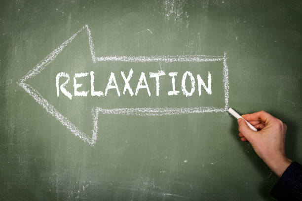istock Relaxation. Arrow and text on a green chalkboard 1390218263