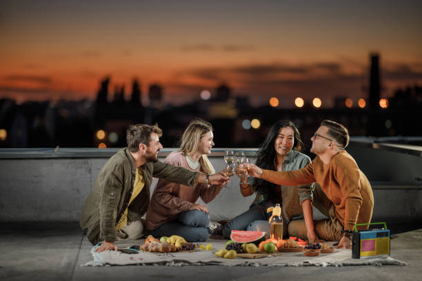 istock Toasting during picnic on a roof at dusk! 1390218276