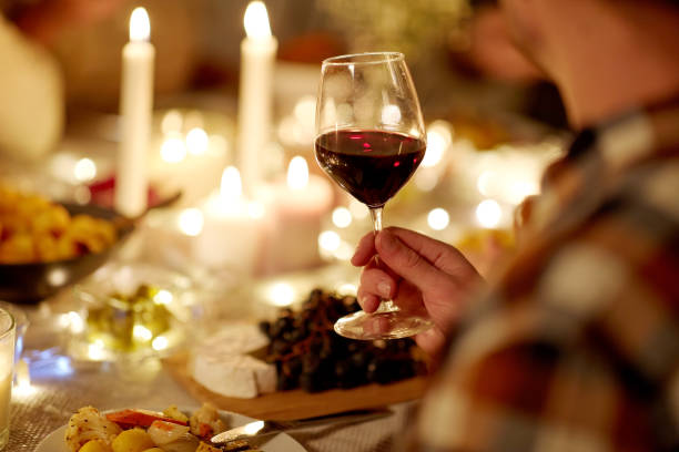 istock friends drinking red wine at christmas party 1390218282