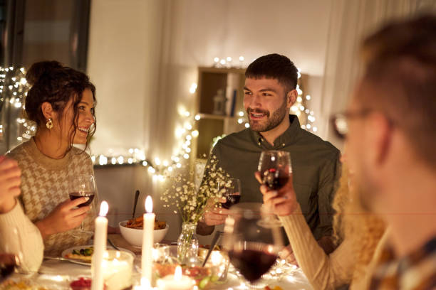 istock happy friends drinking red wine at christmas party 1390218983