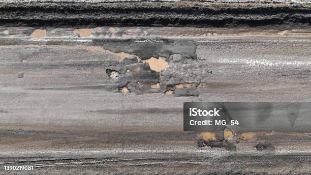 Broken Old Asphalt Road Outside The City Pits And Potholes Aerial View Stock Photo - Download Image Now