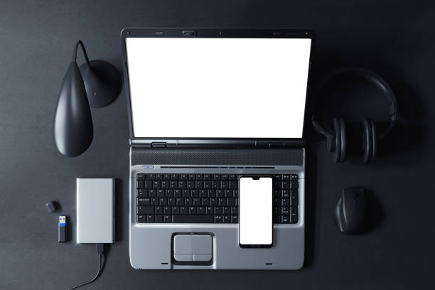 istock Smartphone and laptop at workplace top view scene mockup 1390219099