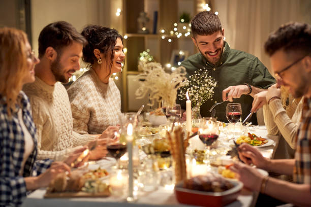 istock happy friends having christmas dinner at home 1390219340