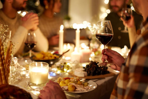 istock friends drinking red wine at christmas party 1390219357