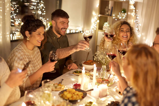 istock happy friends drinking red wine at christmas party 1390220362