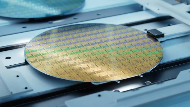 istock Close-up Shot of Silicon Wafer in Bright light at Advanced Semiconductor Foundry, that produces Computer Chips. 1390220565