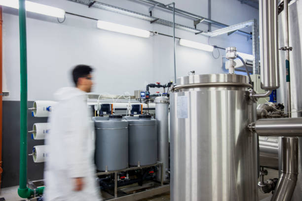 istock Full-length view of a blurry lab technician walking inside an industrial laboratory facility 1390220620