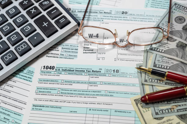 istock Financial document with dollar us 1040 tax form 1390220710