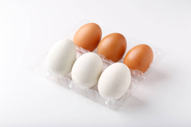istock 3 Duck eggs (White color) and 3 chicken eggs (Brown color) arranged in plastic packaging boxes for sale. 1390220713