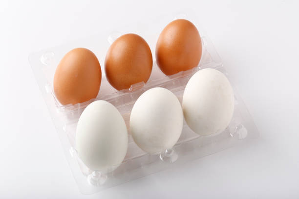 istock 3 Duck eggs (White color) and 3 chicken eggs (Brown color) arranged in plastic packaging boxes for sale. 1390220725