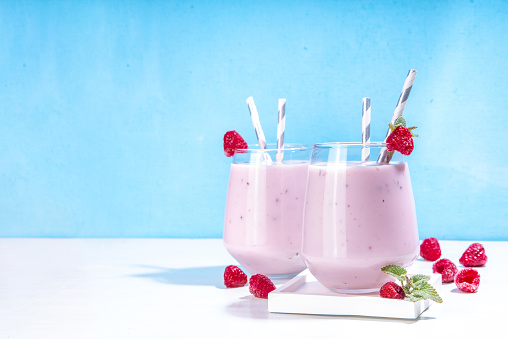Raspberry smoothie, milkshake or yogurt. Fresh raw organic berry drink in glasses