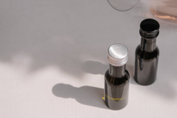 istock White and black corks on small tasting bottles. White and red wine. 1390227778