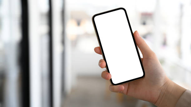 istock Female hand holding a smartphone white screen mockup 1390227976