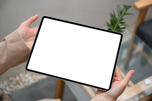 istock Digital tablet white screen mockup in a woman hand 1390228516