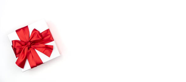 istock Box with a red bow on a white background. The concept of greetings, a gift. 1390229804