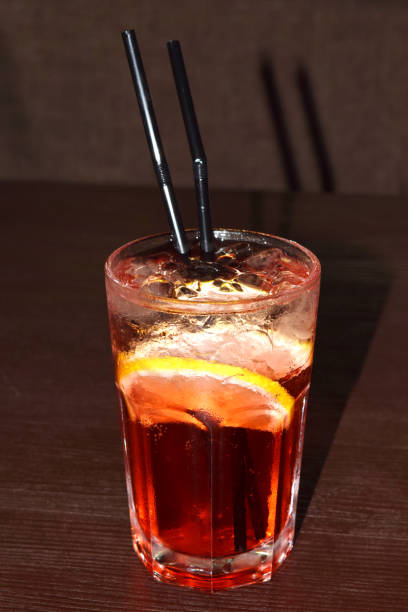 istock refreshing cocktail with a straw, ice cubes and a slice of lemon 1390230290