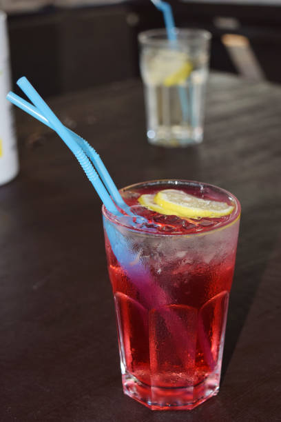 istock refreshing cocktail with a straw, ice cubes and a slice of lemon 1390232019