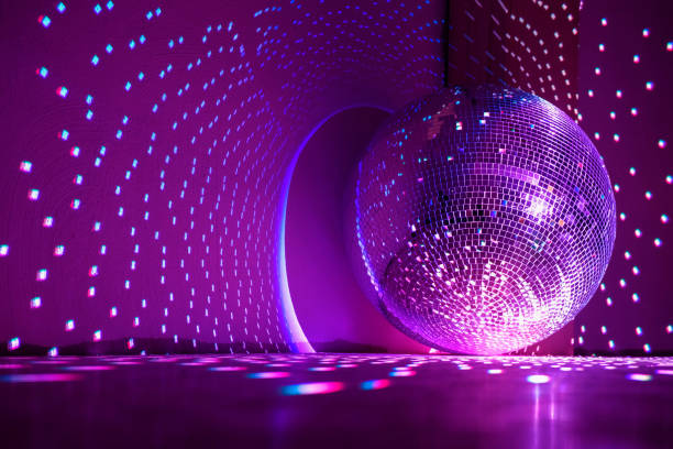 istock Disco ball reflecting violet light in a dark hall. 1390232597
