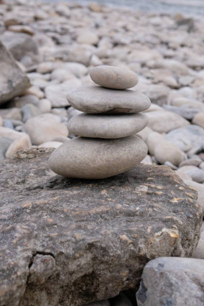 istock Pyramid of smooth stones on a pebble background. River shoreline in Provence. 1390232695