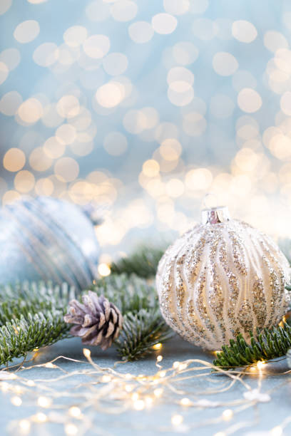 istock Christmas spruce with ball and blurred shiny lights. 1390233654