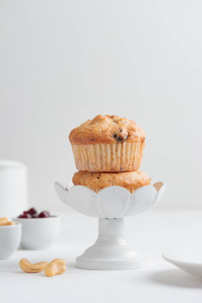 istock Fresh muffins in a cake stand on a white table 1390233730