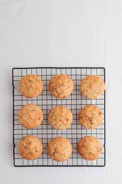 istock Vanilla fresh baked muffins on a white table with nuts and berries 1390233804
