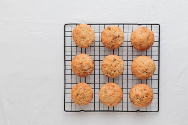 istock Vanilla fresh baked muffins on a white table with nuts and berries 1390233805