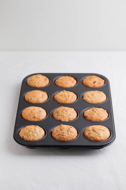 istock Fresh baked muffins in a baking pan 1390234006