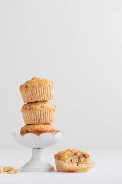 istock Fresh muffins in a cake stand on a white table 1390237142