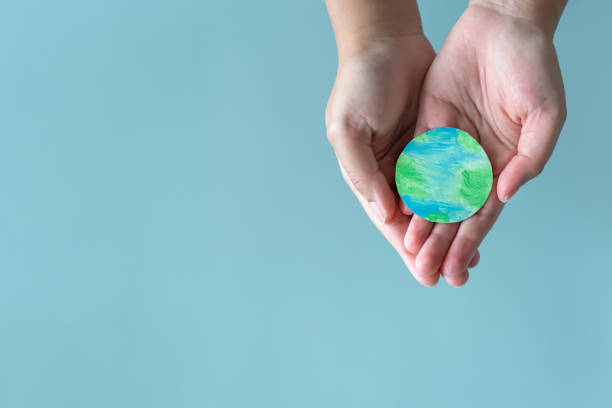 istock Hands holding earth. Concept of protecting the world from global warming. 1390237794