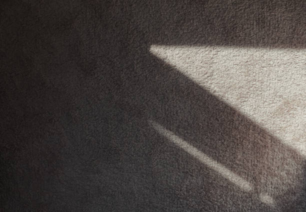 istock Textile carpeting. Abstract texture background. Grey soft carpet in monochromatic color with dark shadows on it. 1390239734