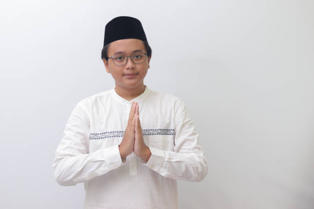 istock Asian muslim man showing apologize and welcome hand gesture 1390241044
