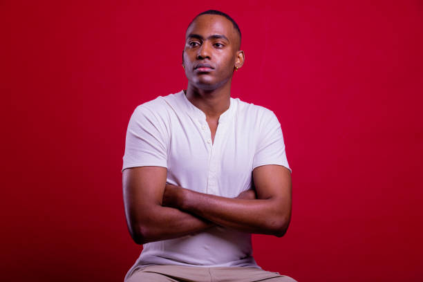 istock Confident young man. Black man portrait in red background. 1390241319
