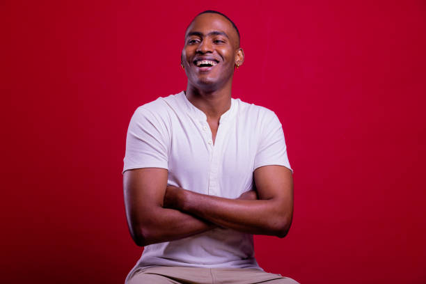 istock Laughing Black man portrait in red background. 1390241338