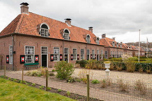 Old terraced houses with colorful wooden shutters in the village of Renswoude in the Netherlands.