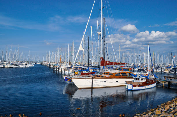 fishing boat moored in harbor on a sunny summer day with bright blue skies and white clouds