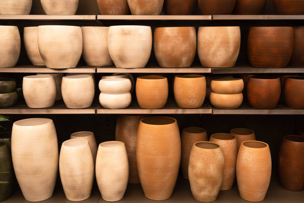 istock Several flower pots in different sizes and colors in a row next to each other. 1390241474