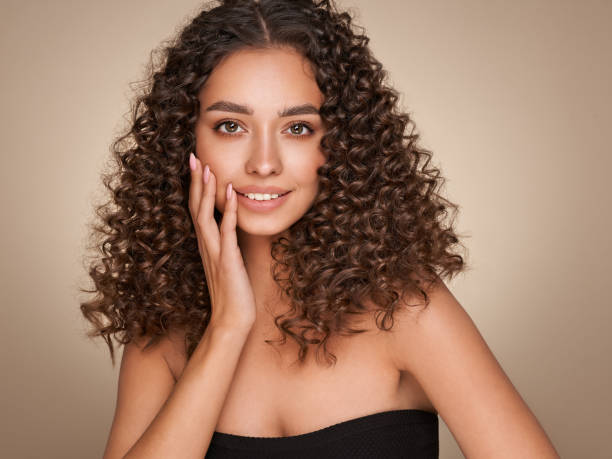 istock Beautiful smiling woman with afro curls 1390242163