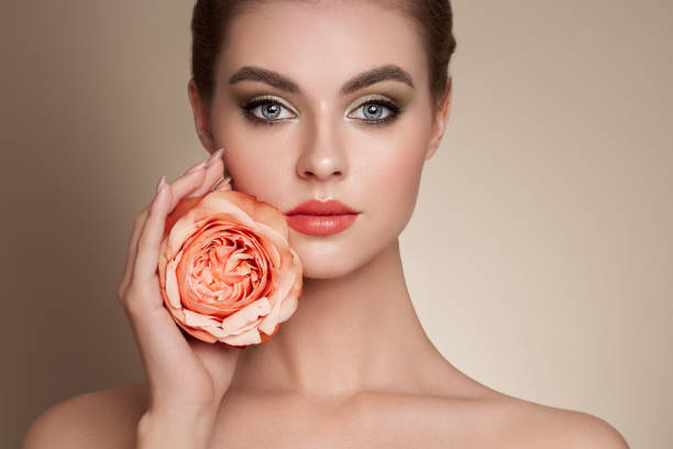 istock Beautiful young woman a rose flower 1390242304