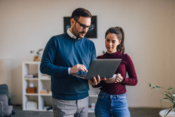 istock People standing, holding, and searching for something over the laptop. 1390242649