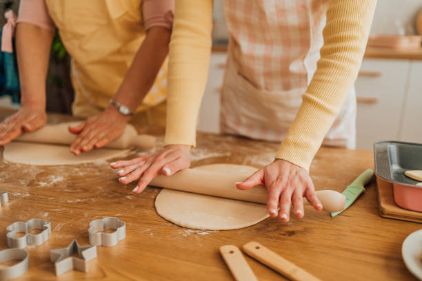 istock Mother and daughter kneading dough 1390243313