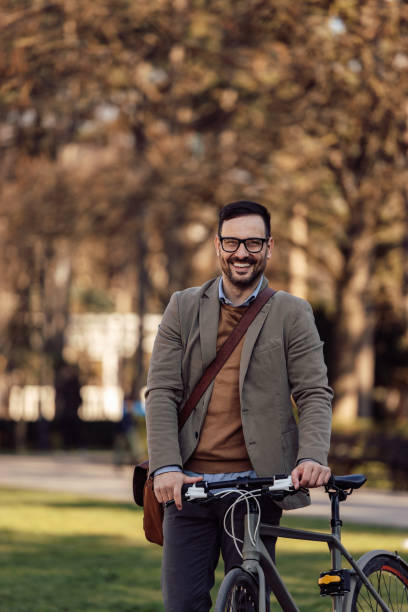 istock Portrait of confident businessman, going home from work on a bicycle. 1390243476