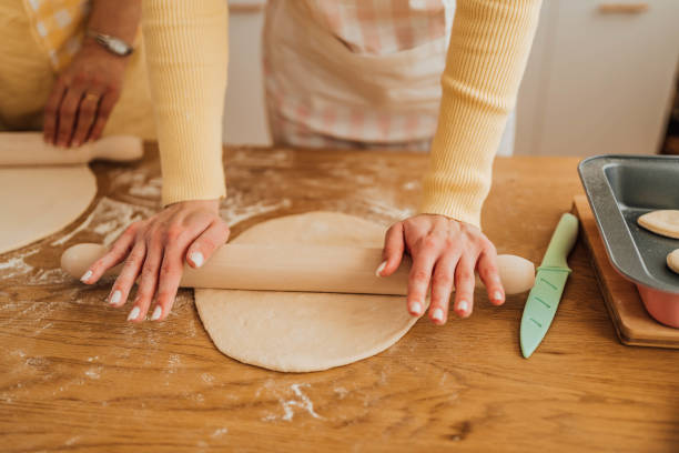 Mother and daughter kneading dough