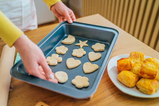 Woman putting cookie dough on a baking tray