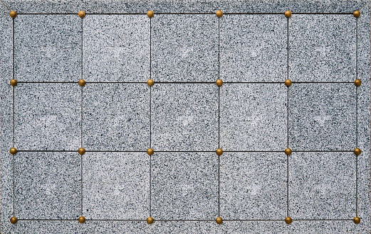 Pattern of granite stone. Behind each square is a space for one urn