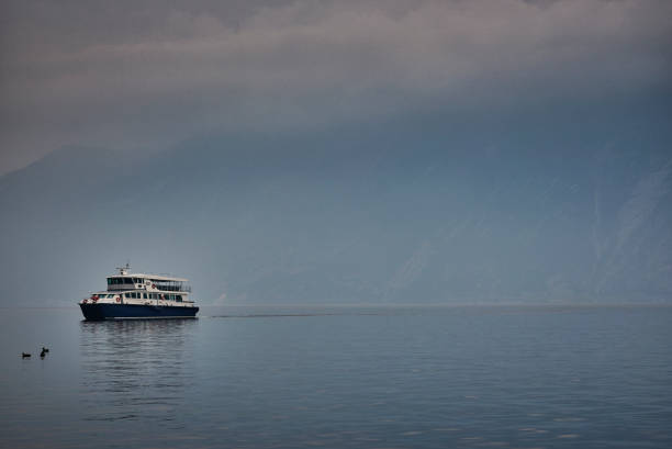 Ferry crossing the lake a foggy and cold day in springtime