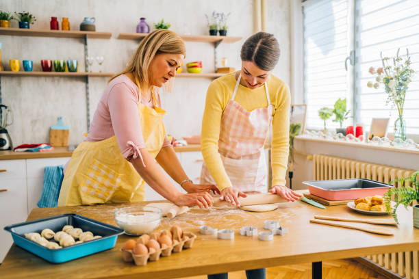 istock Mother and daughter kneading dough 1390244110