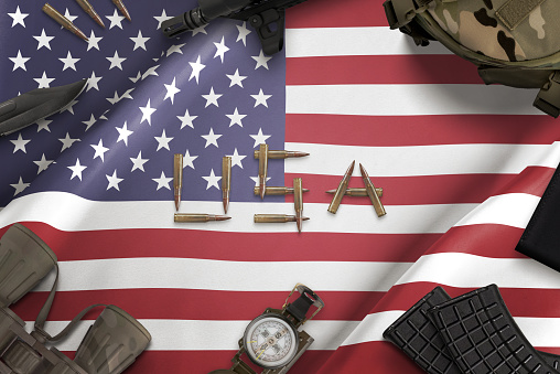 United States of America flag and military equipment. Text writen with bullets