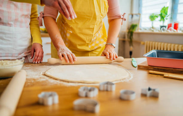 istock Mother and daughter kneading dough 1390244799