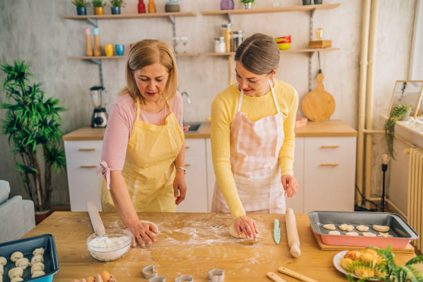 istock Mother and daughter preparing dough 1390244817